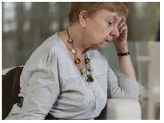 Picture of older woman looking very down and depressed 